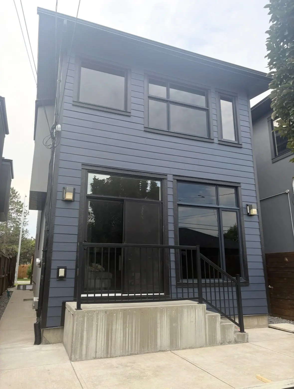siding gutters blue home steps by All About Exteriors