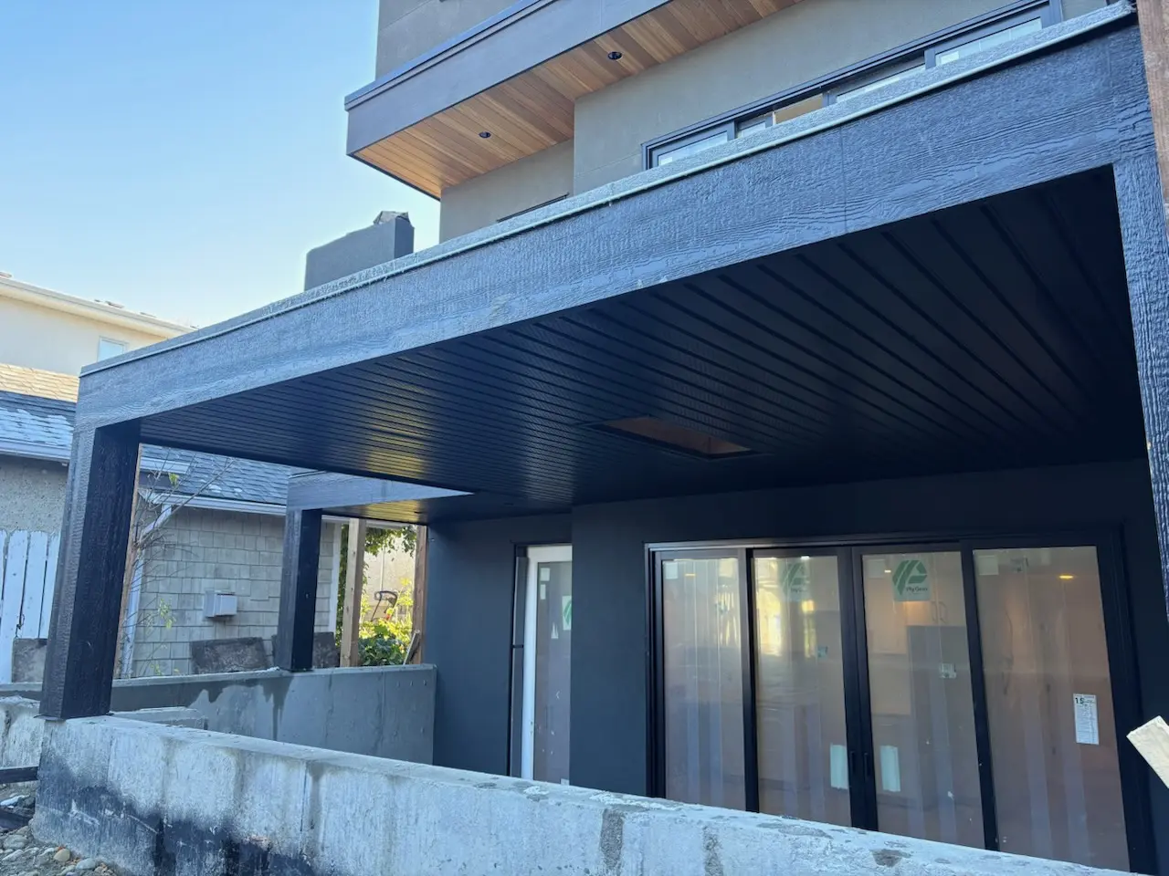 soffit black covered patio by All About Exteriors
