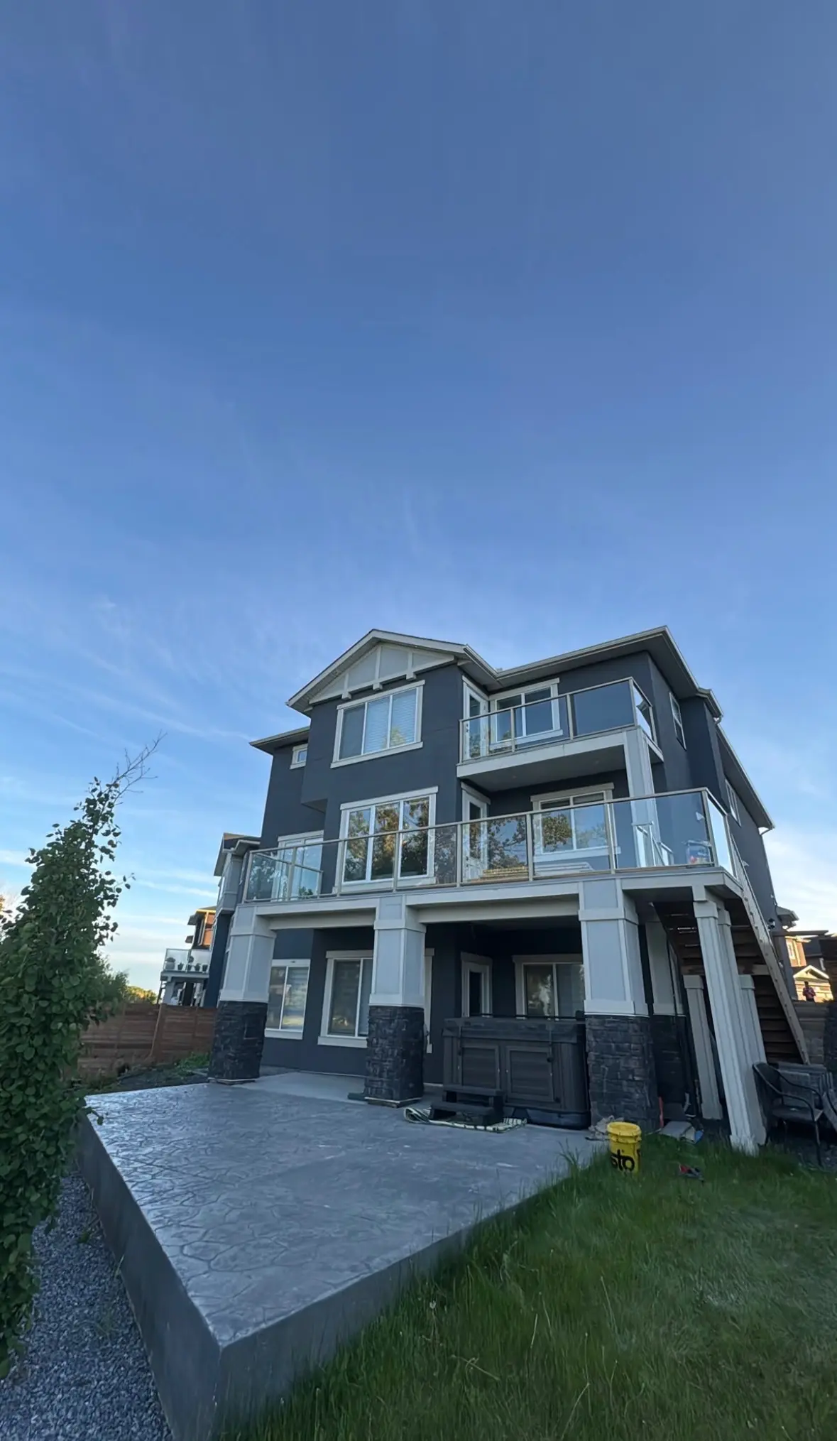 stucco stone three storey patio by All About Exteriors