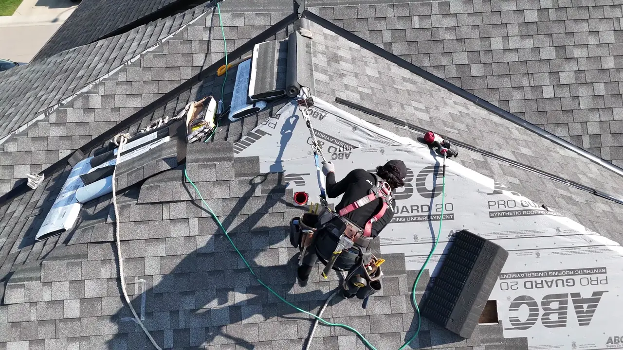 Drone video of a roofer laying ABC Pro Guard 20 underlayment and shingles on a large roof