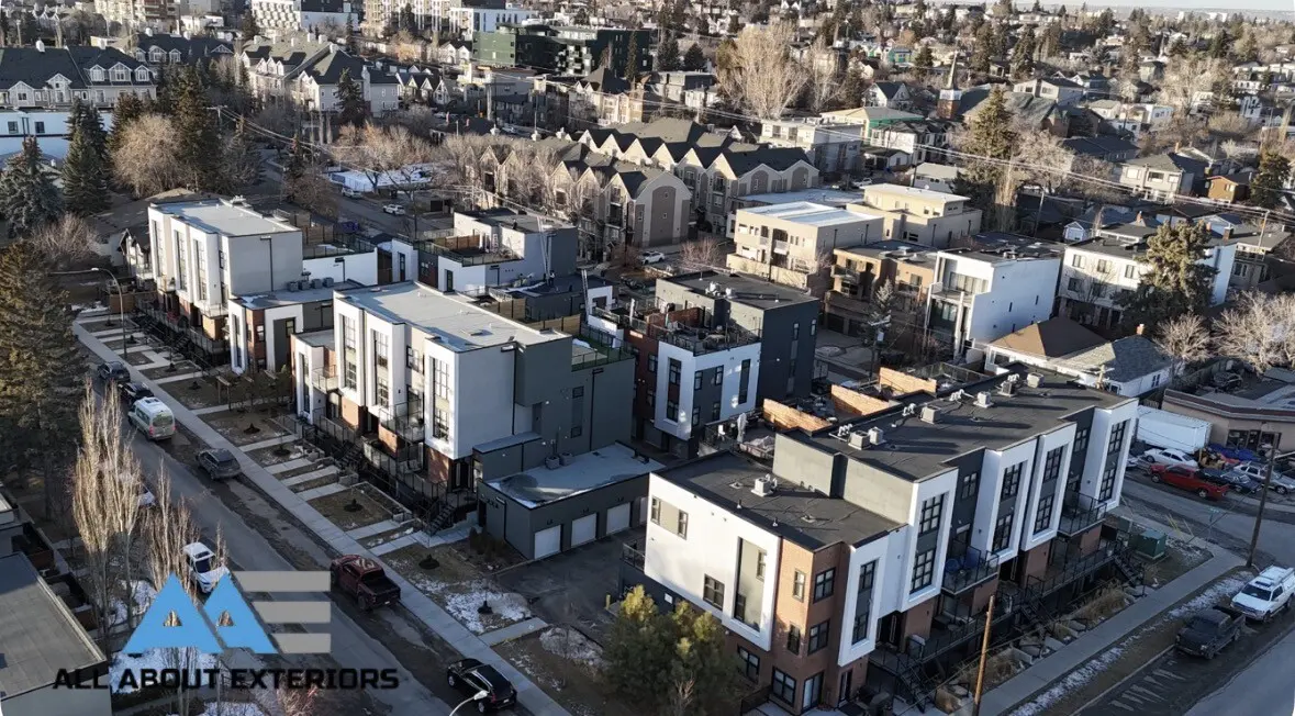 Angled drone view down a street of new modern townhomes