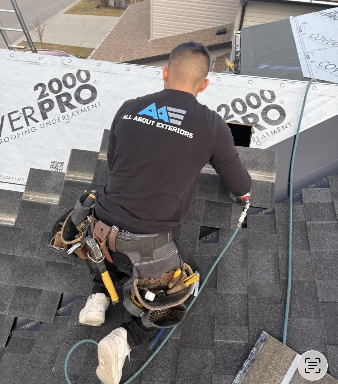 Roofer nailing a new shingle course up to CoverPro synthetic underlayment